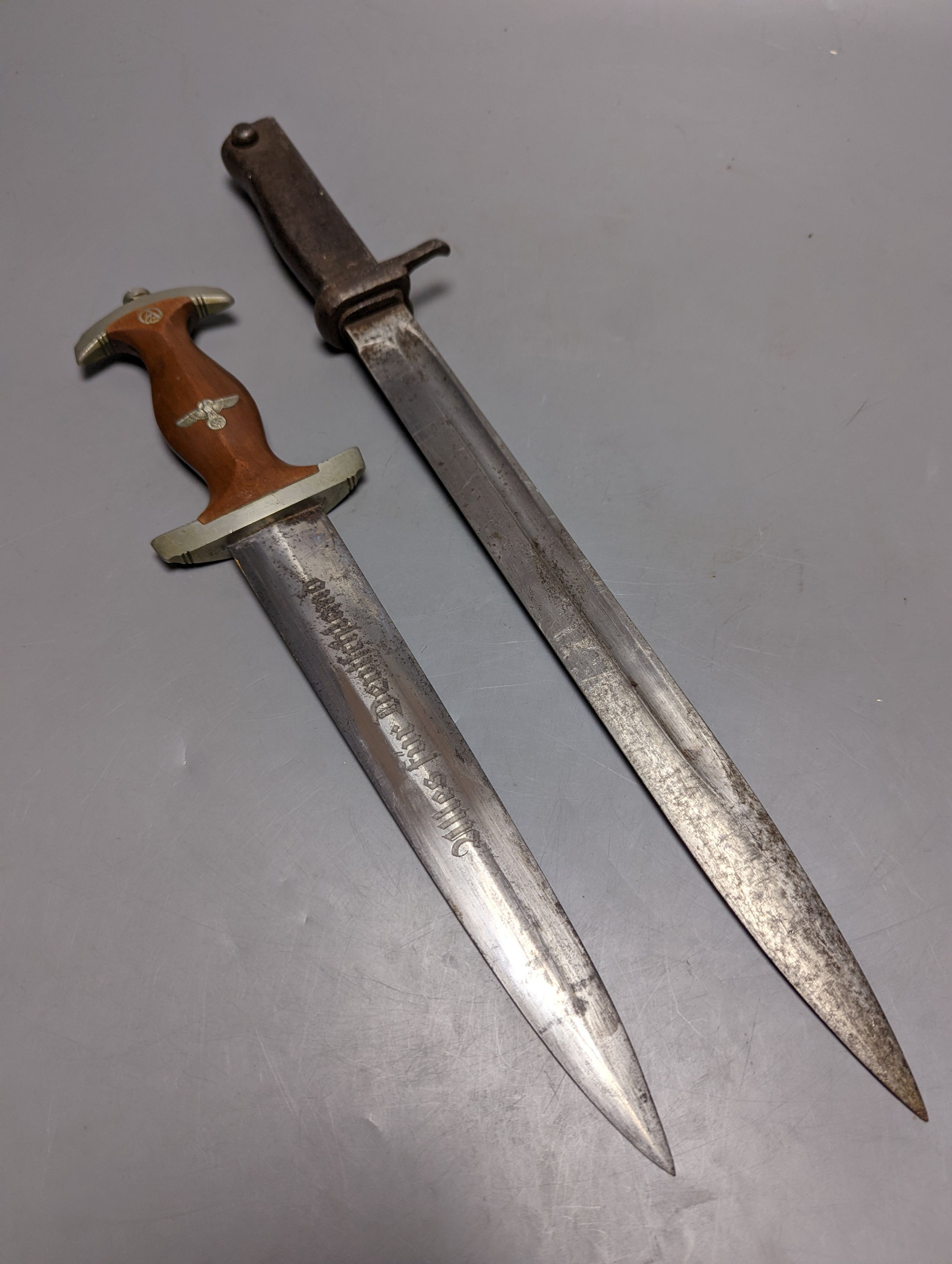 A Third Reich SA dagger within sheath, blade 22cm., and a bayonet within scabbard